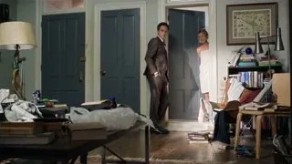 Man explaining to woman in messy room — Suits