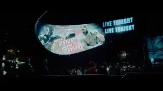 large screen displaying boxing match poster — Creed 2