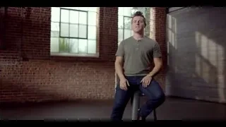 young man sitting on stool in industrial room — The Social Dilemma