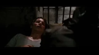 Man with bloody face lying in dark room — Batman: The Dark Knight Rises