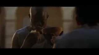 Bald man holding object in dim room — Gladiator