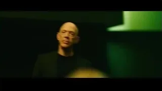 bald man in suit in green light — Whiplash