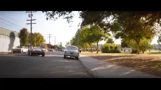 vintage car driving on sunny street — Ford v Ferrari