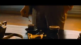 Hand holding spoon preparing tea on table — John Wick: Chapter 4