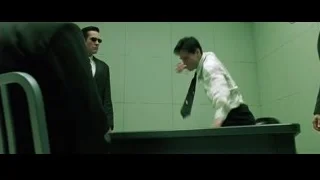 three men in green room with desk — The Matrix