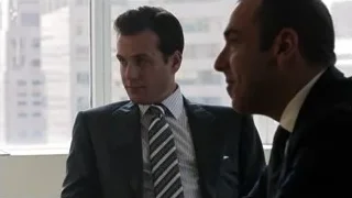 two men in suits conversing in office — Suits
