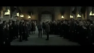 People in formal attire in hall archway — Harry Potter and the Deathly Hallows 2
