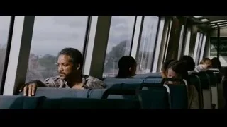 Man on train looking out window at mountains — The Persuit of Happyness