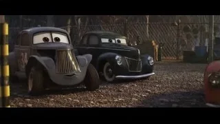 Two Cars characters parked in dirt lot — Cars 3