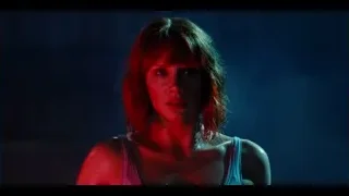 woman in dark room with blue and red light — Jurassic World