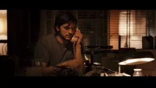 Man talking on phone in dimly lit office — Jobs