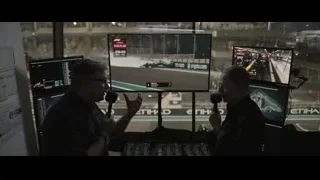 two men watching F1 race in control room — F1