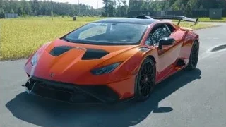 orange Lamborghini sports car parked on road — Sports Cars