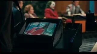 Joker and man at TV show desk — Joker
