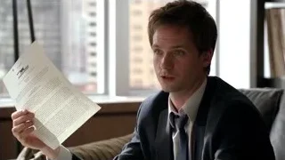Man on couch holding paper city view — Suits