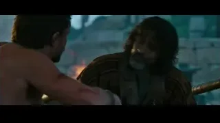 two men arguing with sword in rocky landscape — Gladiator 2