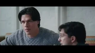 two men conversing on couch in living room — The Big Short