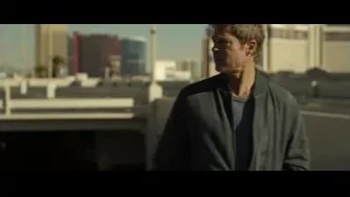 man walking on rooftop with city skyline — F1