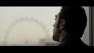 man looking out window at city skyline — F1