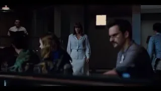 woman holding phone looking surprised — Jurassic World