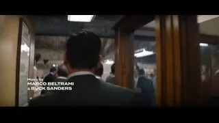 Men in suits in large room — Ford v Ferrari