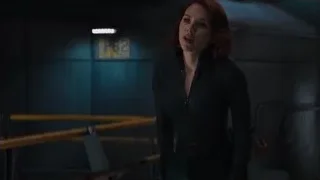 Woman standing in a dark room — The Avengers