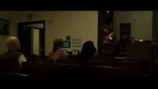man in suit sitting in church pew — Fight Club