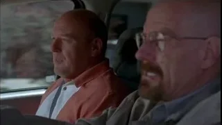 two men in car one in orange uniform — Breaking Bad