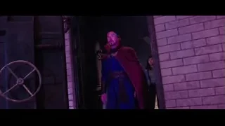 man in blue coat with red cape in doorway — Doctor Strange 2