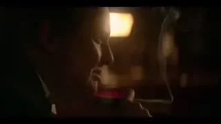 man smoking cigarette in dimly lit room — Peaky Blinders