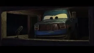 blue pickup truck parked in wooden garage — Cars 3