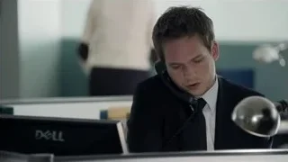 Man in suit holding telephone at office desk — Suits
