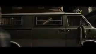 man in racing suit van doorway — F1