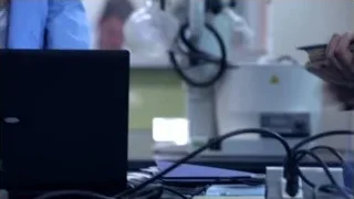 young woman deep in thought in laboratory — Suits