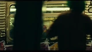 person looking out graffiti train window — Joker