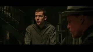 Two men in dimly lit room with staircase — Now You See Me 2