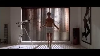 Shirtless man dancing in room with window — American Psycho