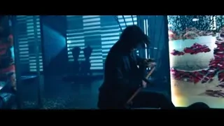man kneeling with gun in dark room — John Wick: Chapter 4
