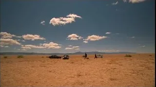 People and cars in desert landscape — Breaking Bad