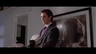 Person's hand holding a gun — American Psycho