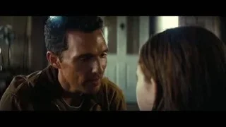 man and woman facing in dim room — Interstellar