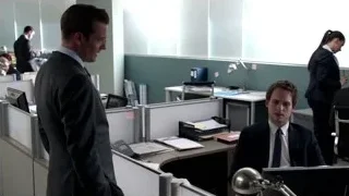 Man in suit standing in busy office cubicle — Suits