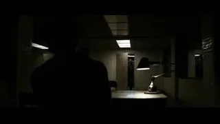 man in dimly lit prison cell — Batman: The Dark Knight