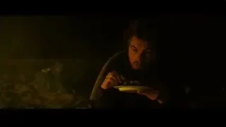 young man sitting in tent holding plate of food — Into the Wild