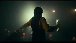 man singing on dimly lit stage — Joker