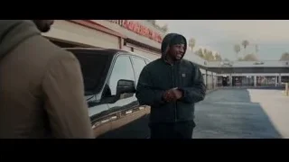 man in black hoodie smiling at SUV — Creed 3