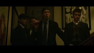 group of men conversing in dim light — The Social Network