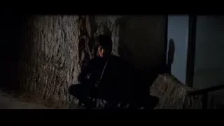 Man sitting on ground in dark tunnel — Bruce Lee: Enter The Dragon