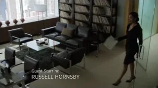 woman walking in modern office with city view — Suits