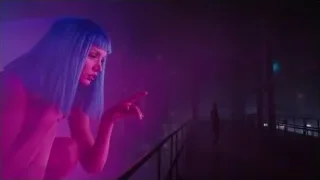 young woman kneeling on foggy balcony — Blade Runner 2049